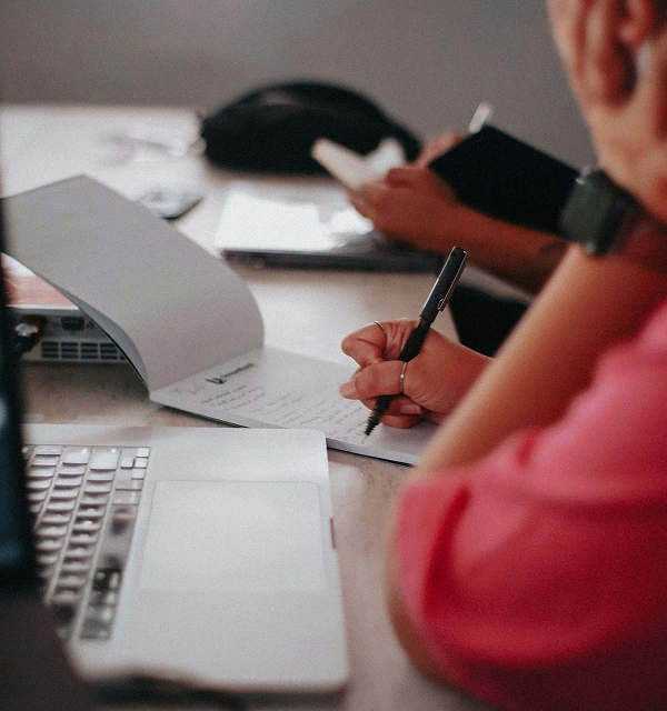 Business consultant reviewing financial notes and cash flow plans — Protea Consulting emergency funding support