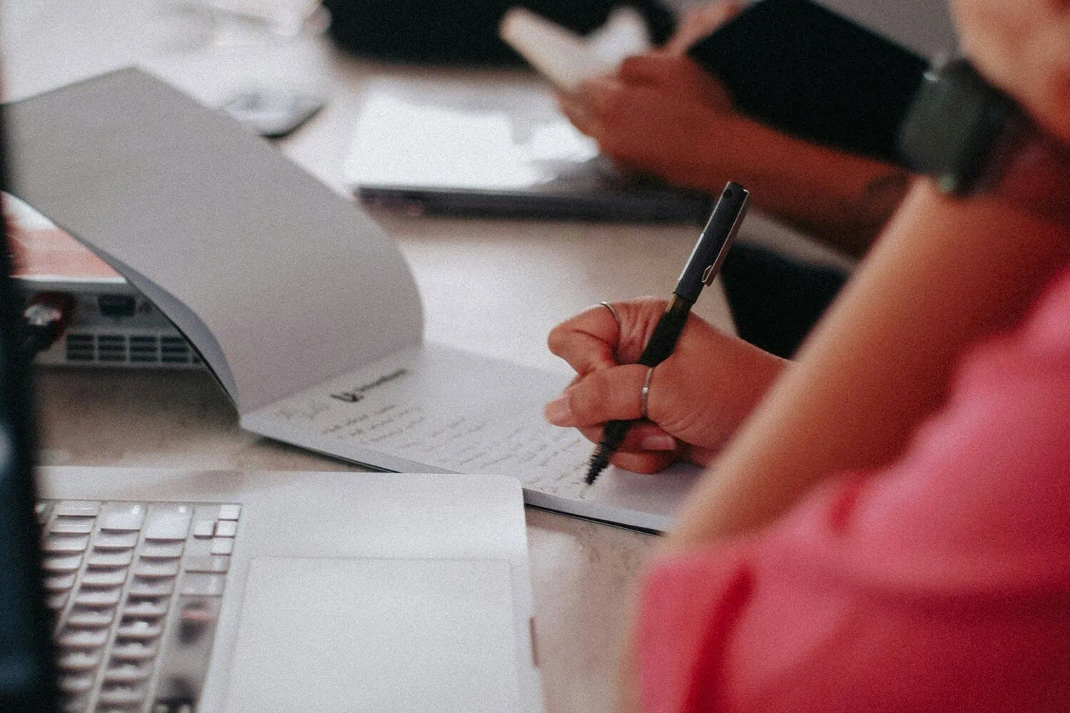 Professional writing notes during a financial planning session