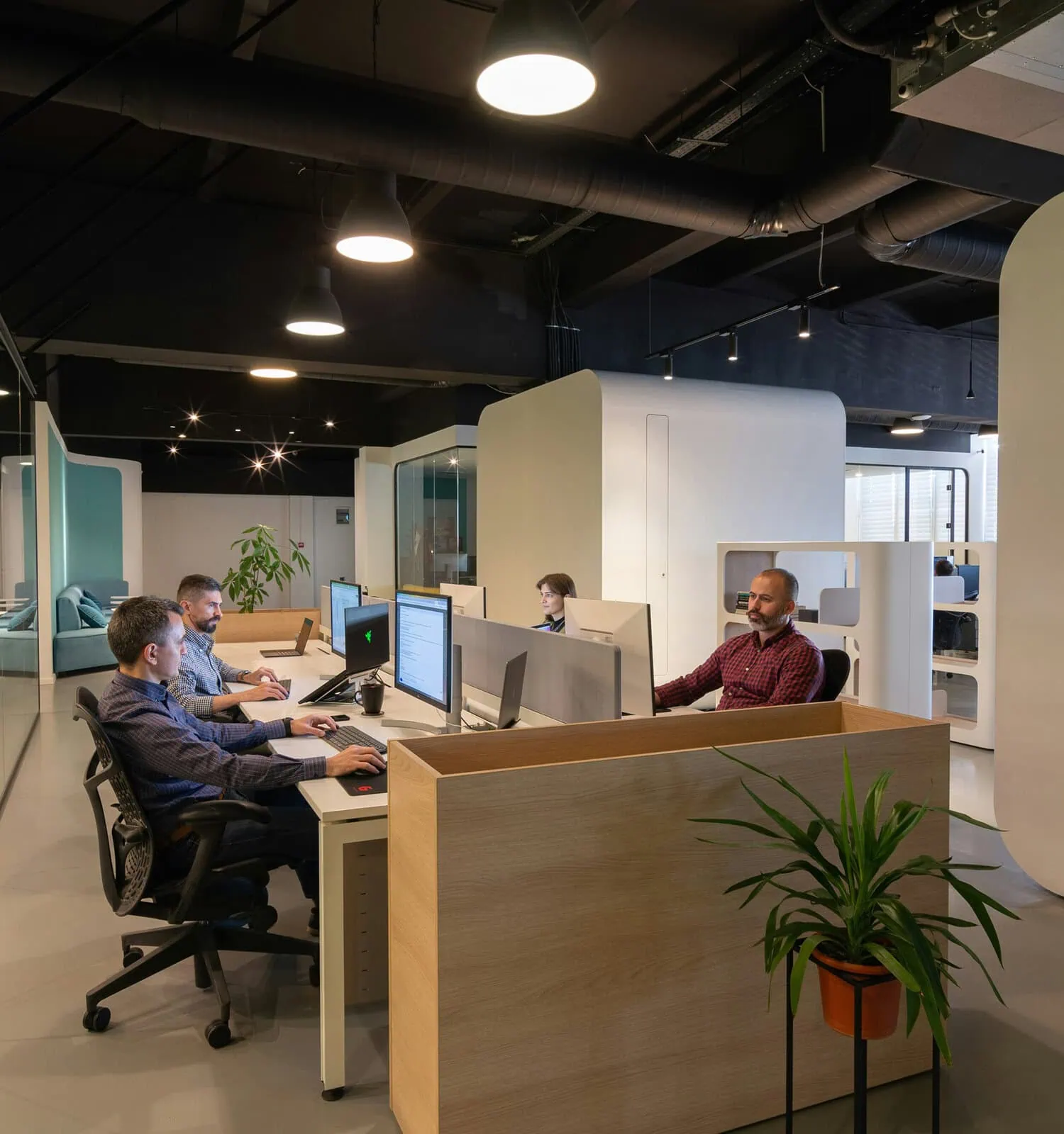 Team collaborating in a large, modern office workspace