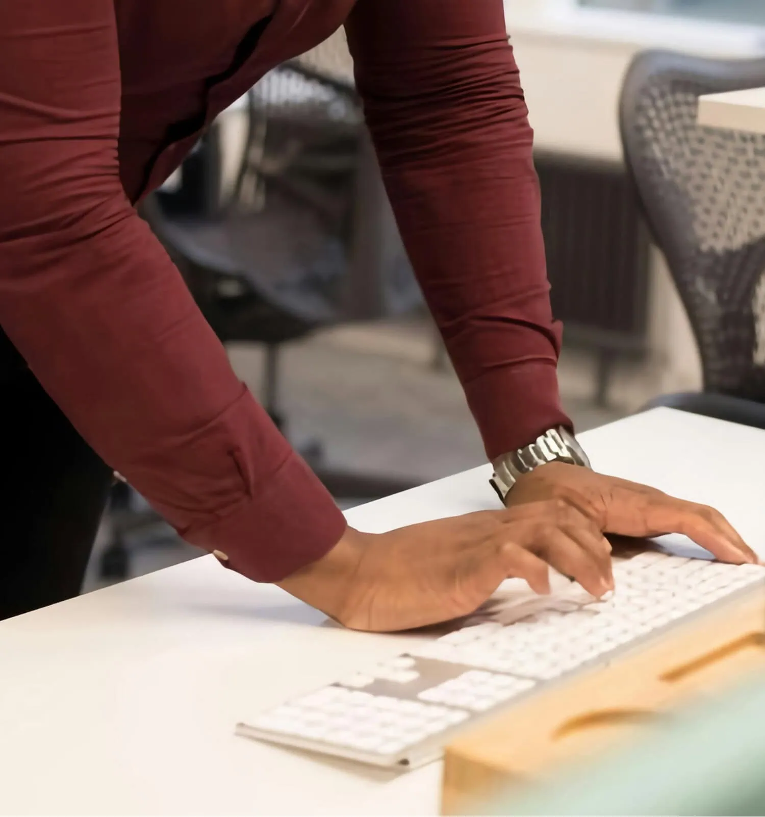 Hands typing on a laptop reviewing financial information