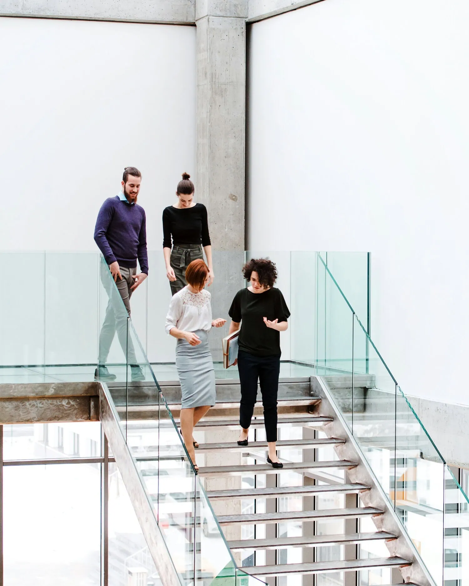 Leadership team walking together in modern office discussing company growth