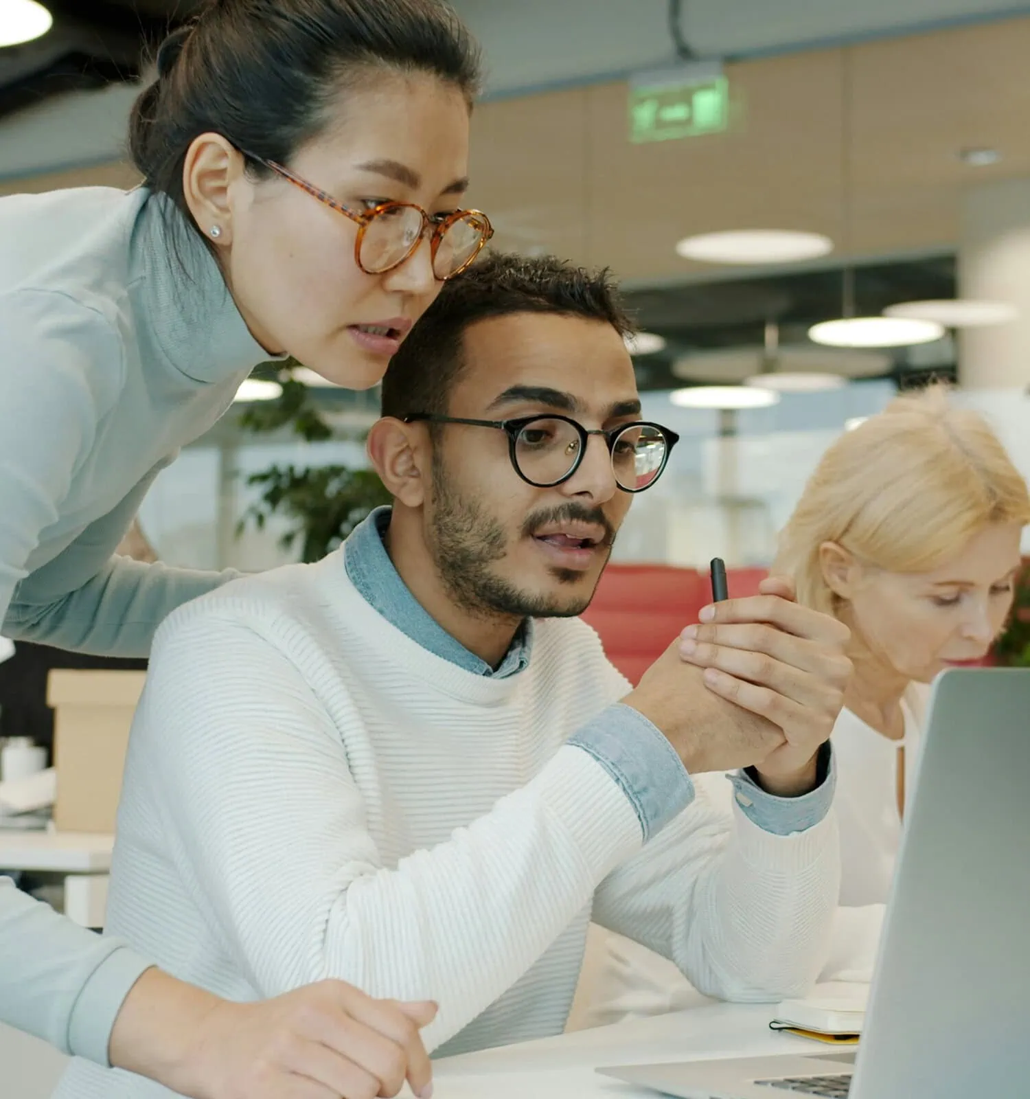 Consultants reviewing information together on a laptop